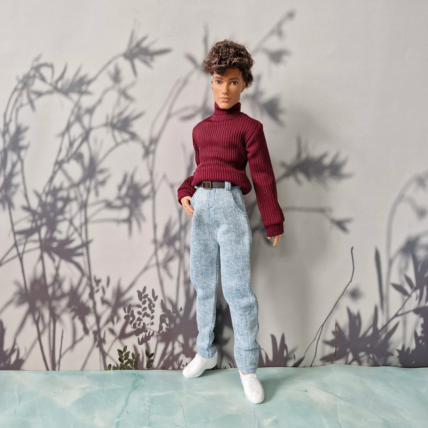 Handsome doll wearing a burgundy red turtleneck sweater and light blue jeans for Ken.