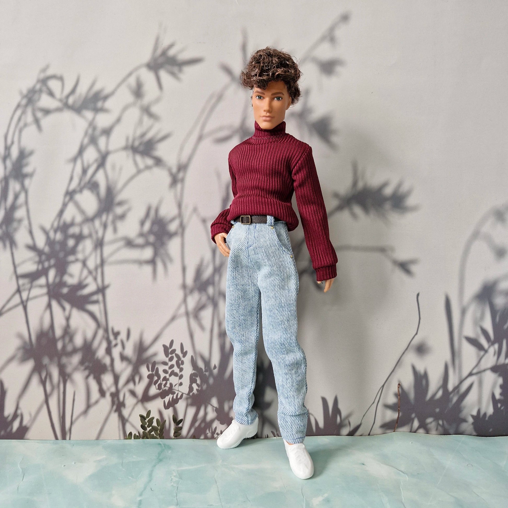 Handsome doll wearing a burgundy red turtleneck sweater and light blue jeans for Ken.
