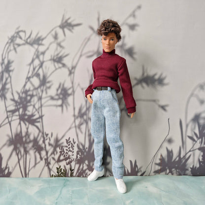 Handsome doll wearing a burgundy red turtleneck sweater and light blue jeans for Ken.
