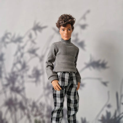 Trendy winter clothes for Ken featuring a grey ribbed sweater and black plaid trousers.