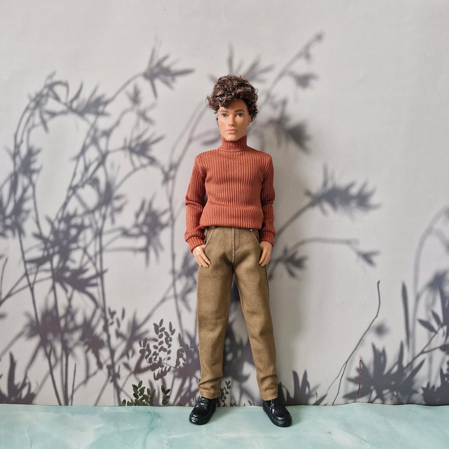 Stylish fall outfit featuring a rust orange ribbed turtleneck and solid khaki pants for Ken.