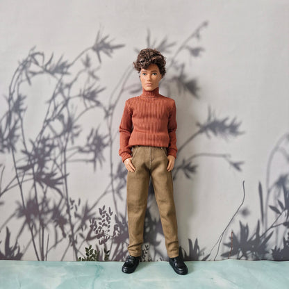 Stylish fall outfit featuring a rust orange ribbed turtleneck and solid khaki pants for Ken.