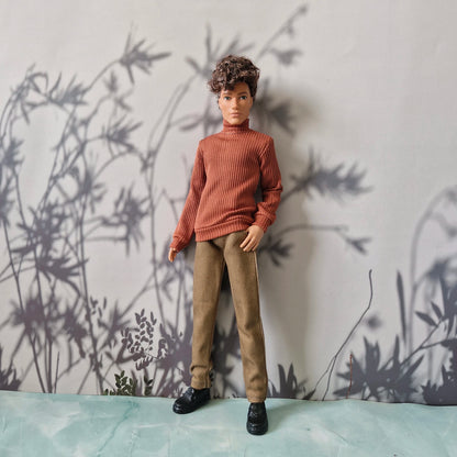 Casual everyday fashion showing an orange turtleneck, solid khaki pants, and black shoes for Ken.