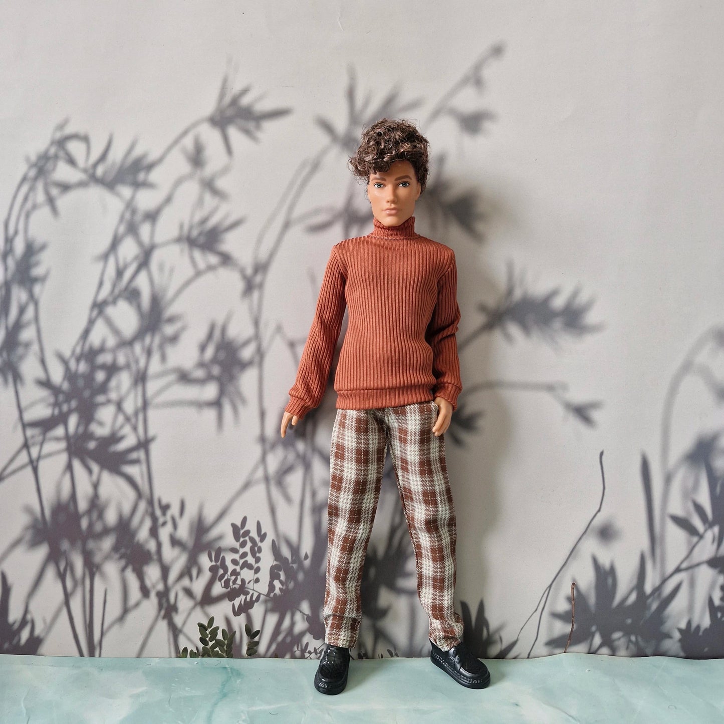 Stylish clothes for Ken featuring a brown long-sleeve turtleneck and tailored plaid pants.
