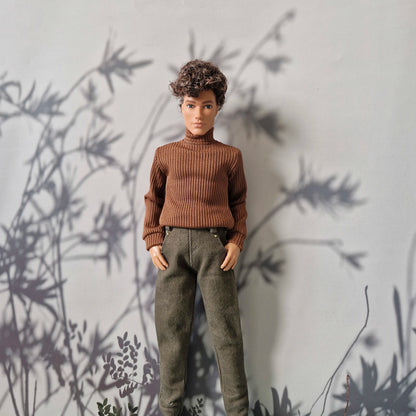 Close-up of a brown long-sleeve turtleneck top and solid green pants for Ken.