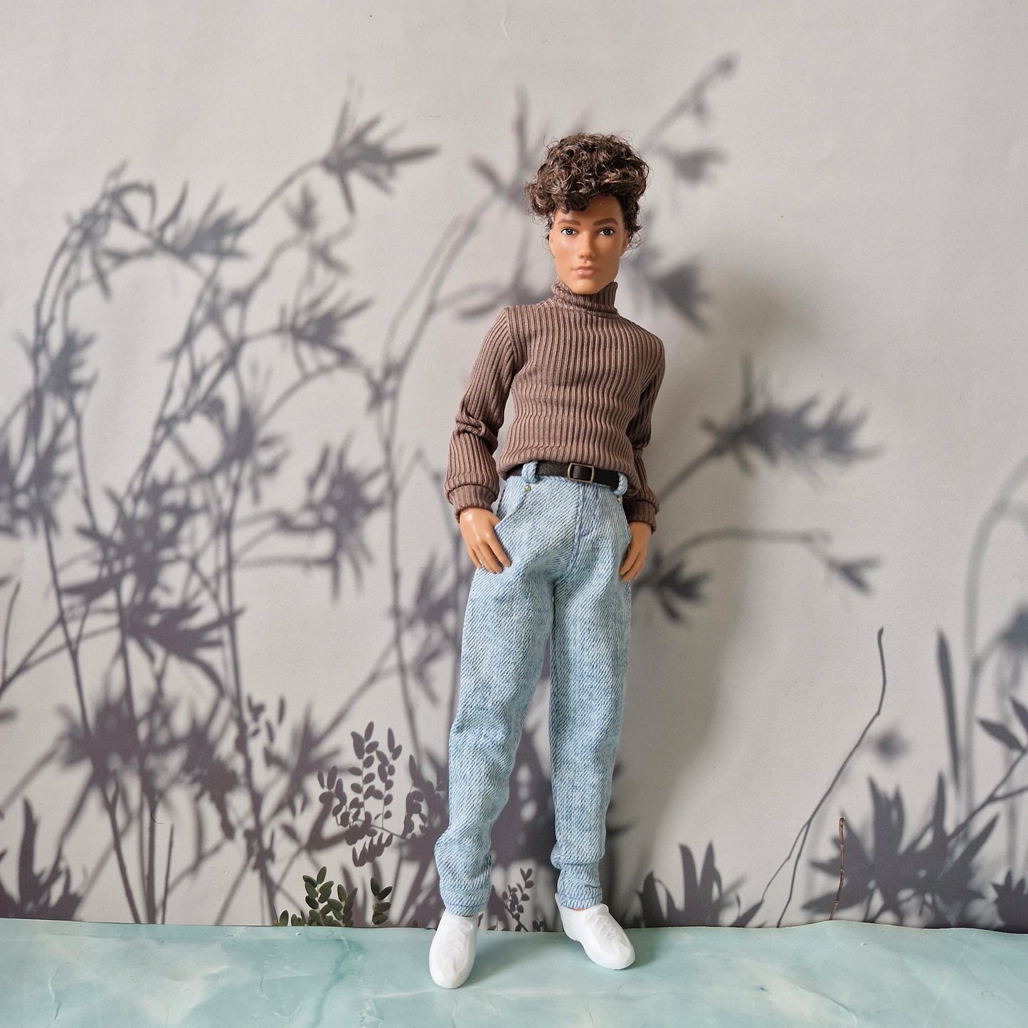 Doll dressed in a stylish brown ribbed sweater and light blue denim jeans for Ken.