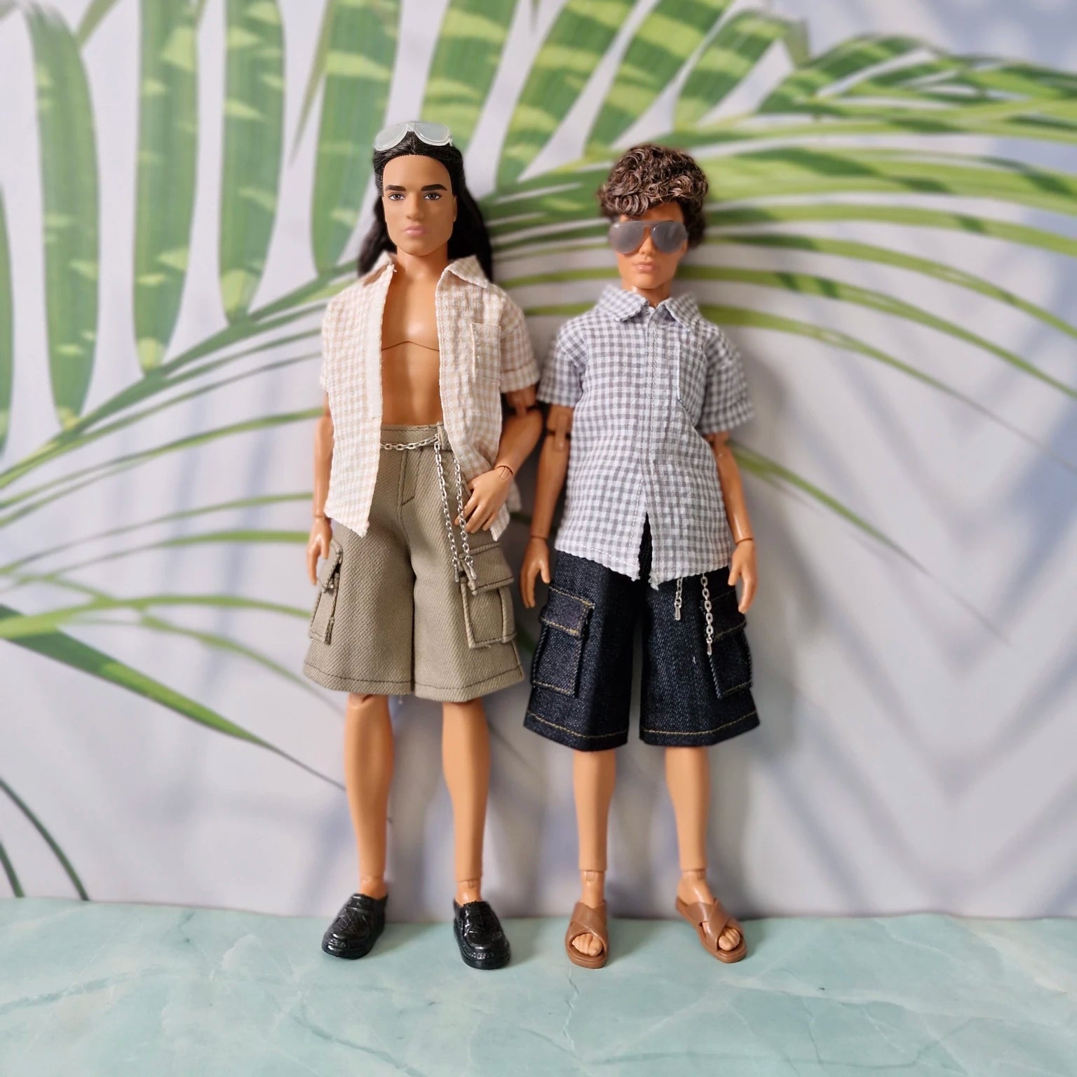 Two male dolls standing together modeling mix and match gingham shirts and cargo shorts separates for Ken.