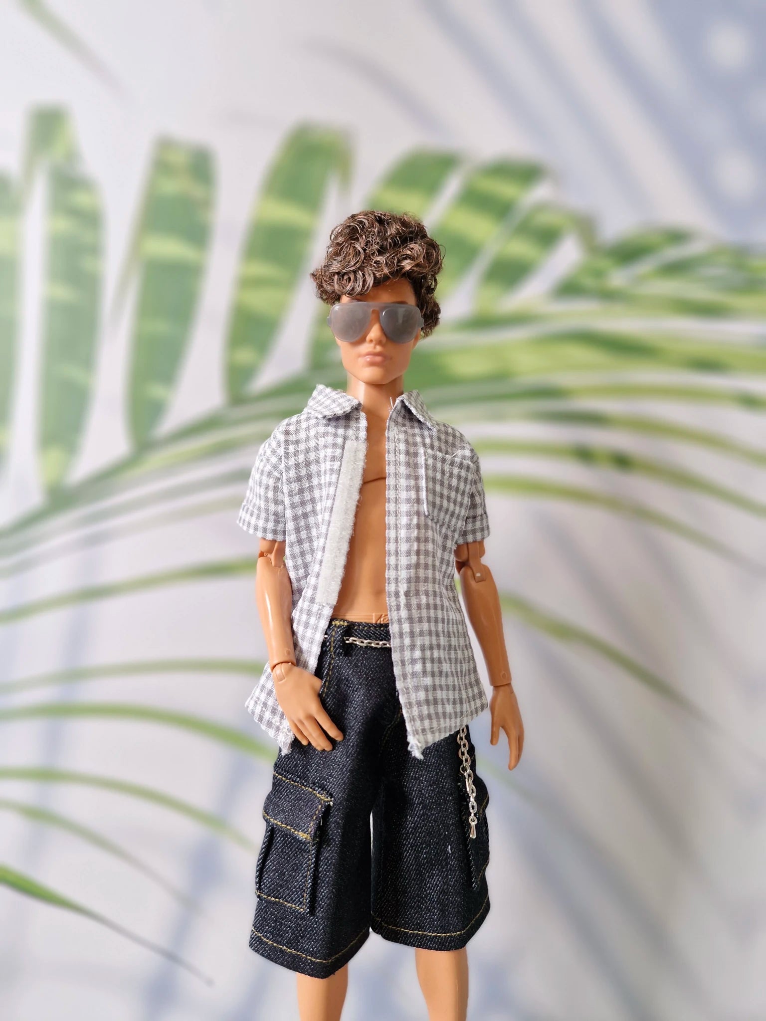 1/6 scale male doll wearing an unbuttoned grey gingham shirt, dark denim shorts, and stylish sunglasses for Ken.