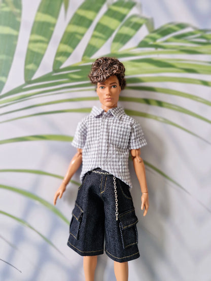 Close up of a 1/6 scale male doll modeling a casual grey gingham shirt and dark denim pocket shorts for Ken.