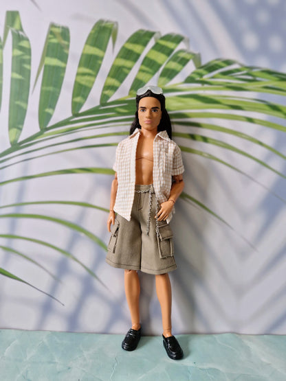 Long-haired 1/6 scale male doll wearing an unbuttoned beige gingham shirt and khaki cargo shorts with a chain for Ken.