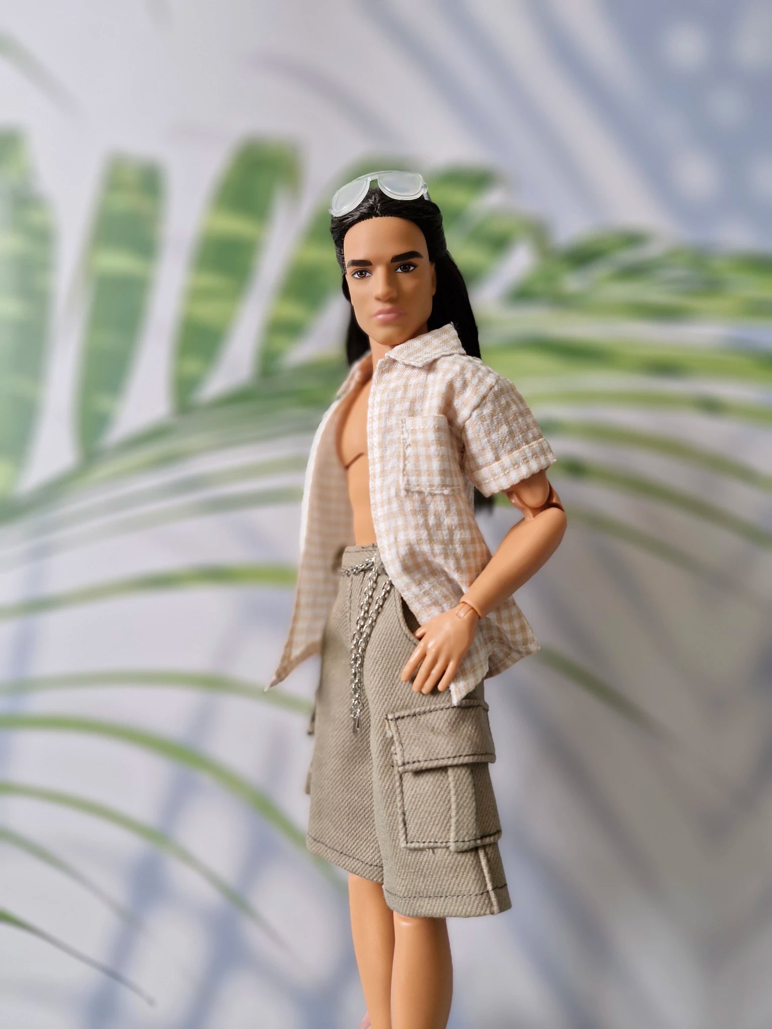 Side profile of a 1/6 scale fashion doll modeling a beige summer shirt and khaki cargo shorts sold separately for Ken.
