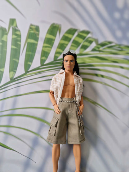 Male doll posing in a casual unbuttoned beige top and khaki cargo shorts with chain details for Ken.
