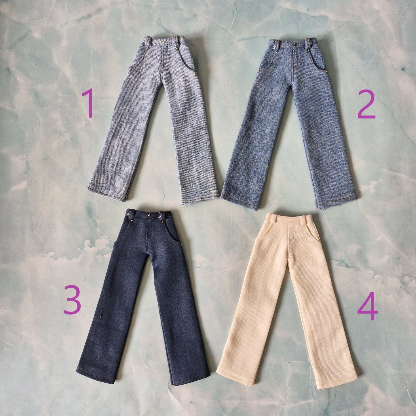 Flat lay of 4 pairs of handmade 1/6 scale trousers for Ken dolls, numbered 1 to 4.