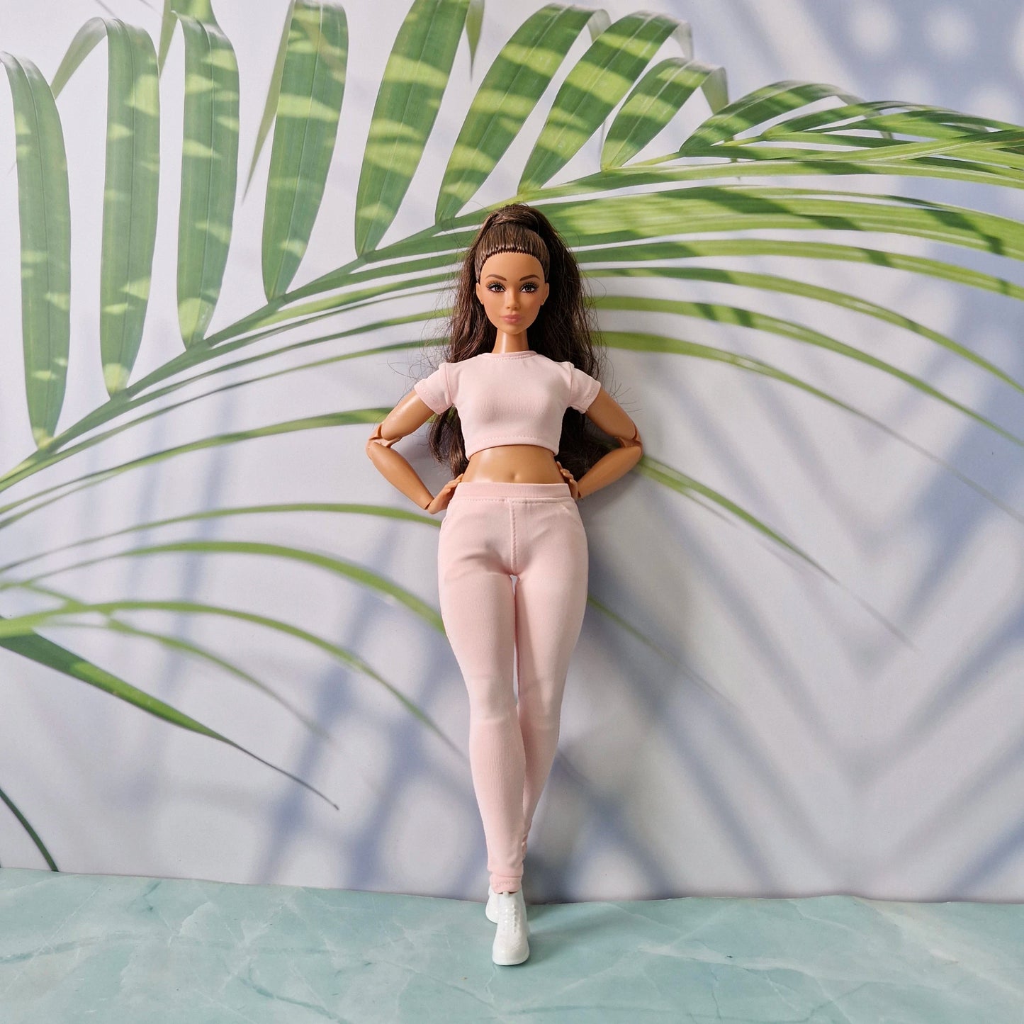 Curvy fashion doll wearing a stylish light pink ribbed top and matching pants tailored for Curvy.