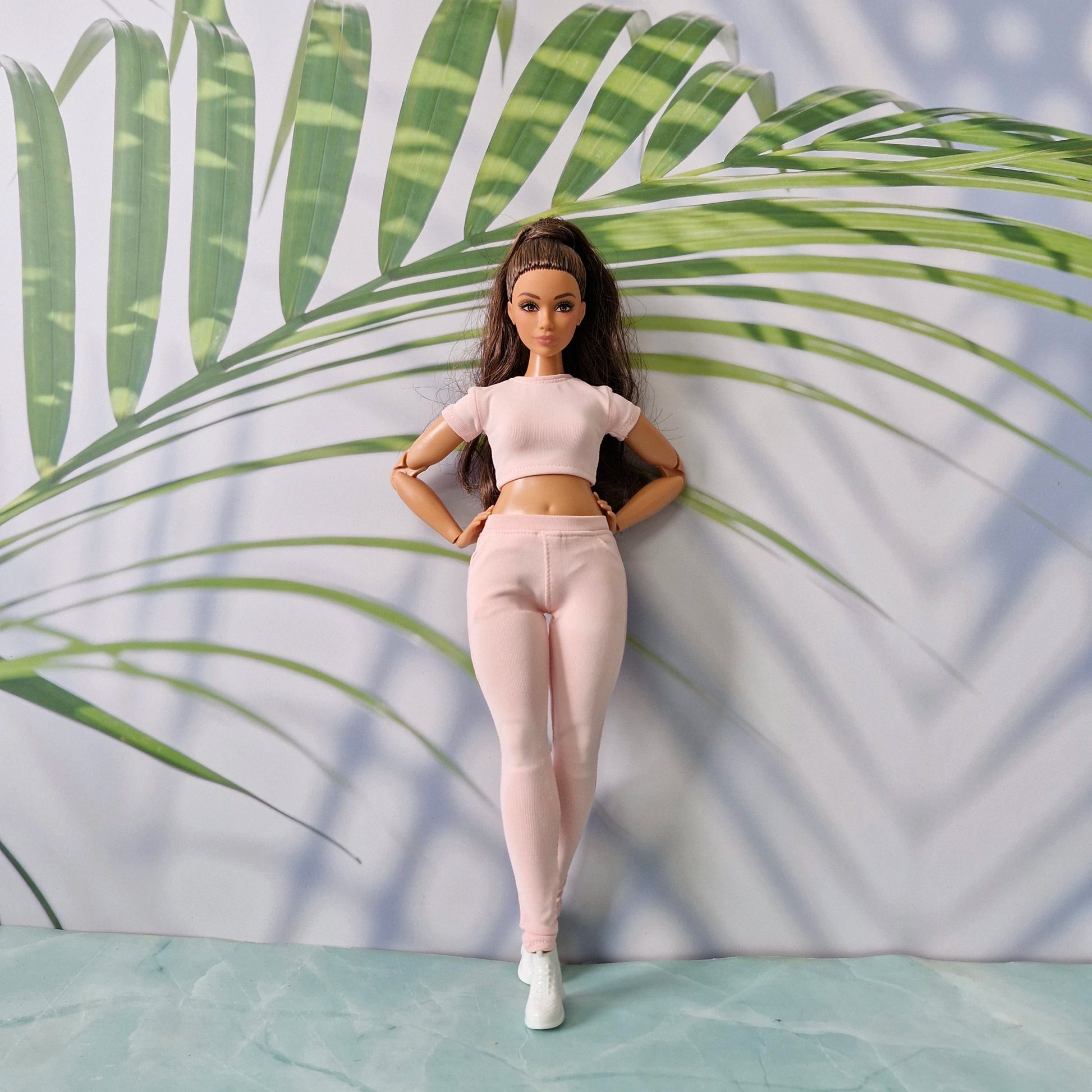 Curvy fashion doll wearing a stylish light pink ribbed top and matching pants tailored for Curvy.