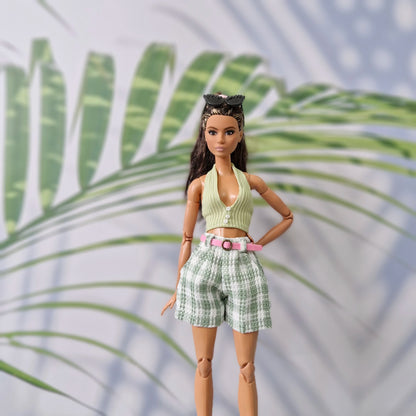 Brunette fashion doll wearing a green ribbed halter top and matching green plaid shorts for Barbie.