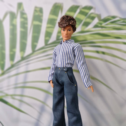 Ken doll wearing a handmade blue and white striped shirt tucked into dark blue trousers.