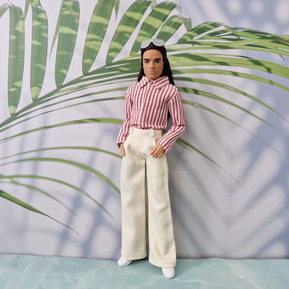 Ken doll wearing a handmade blue and white striped shirt tucked into dark blue trousers.