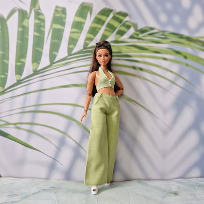 Full body shot of a Curvy Barbie wearing a handmade green summer top and pants outfit with white shoes.