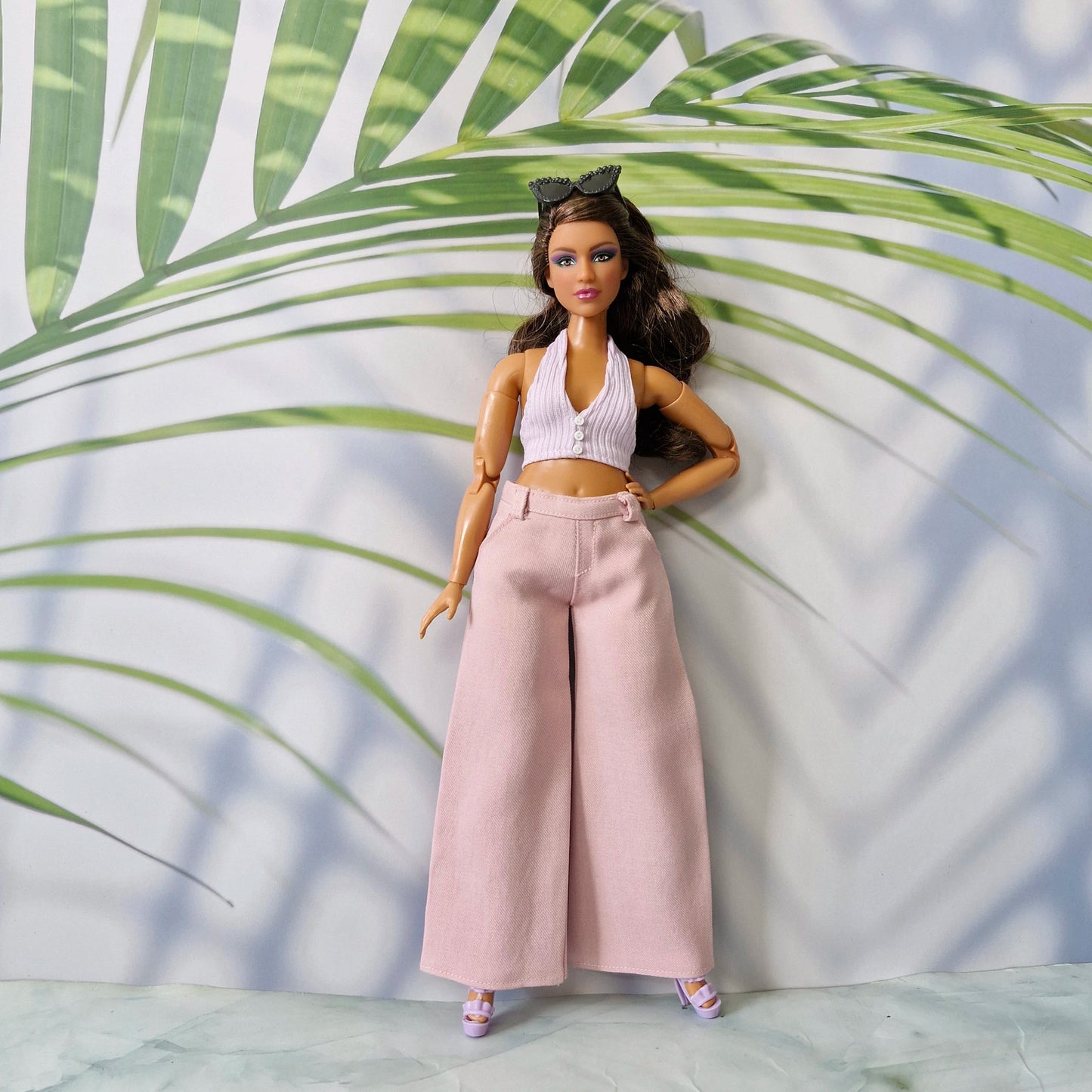 1/6 scale Curvy fashion doll modeling a handmade pink ribbed button-front top and matching pink trousers.