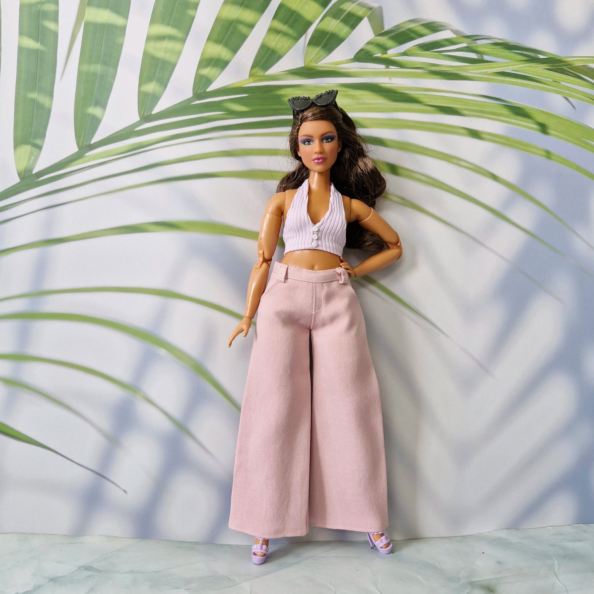 1/6 scale Curvy fashion doll modeling a handmade pink ribbed button-front top and matching pink trousers.