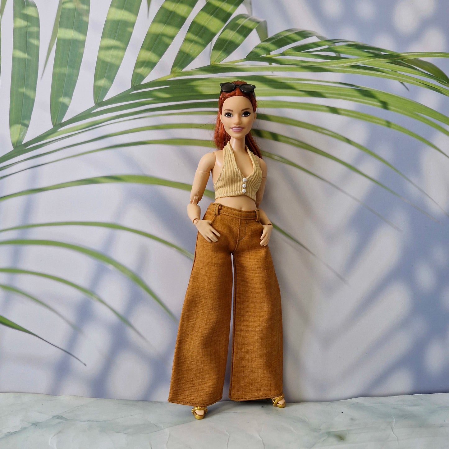 Curvy Barbie doll posing in a handmade 1/6 scale beige top and brown wide-leg trousers outfit.