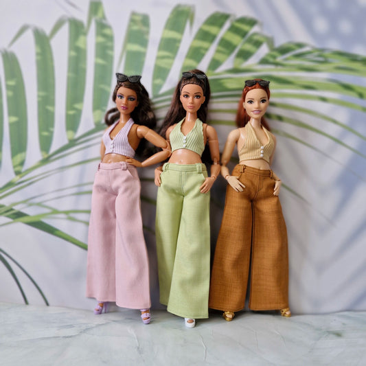 Three Curvy Barbie dolls wearing handmade 1/6 scale ribbed halter tops and wide-leg pants in pink, green, and brown.