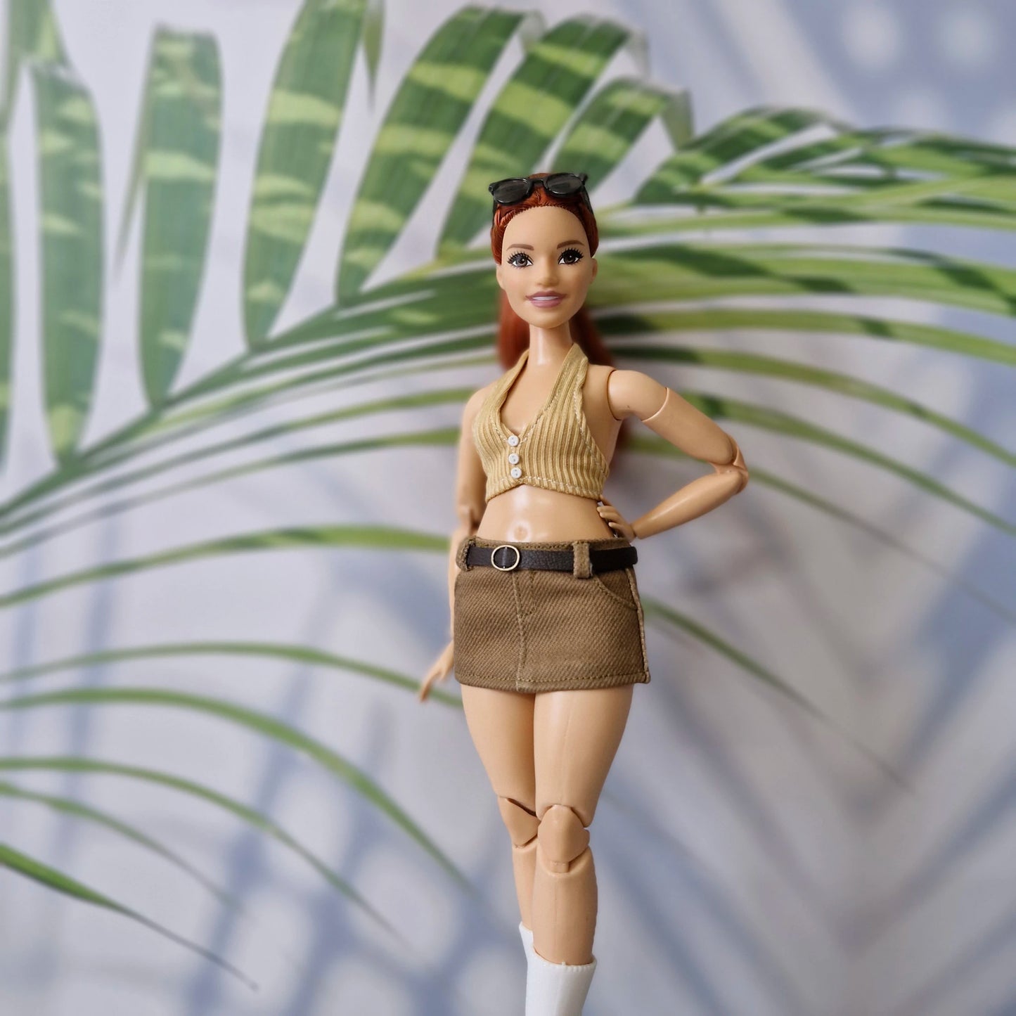 Red-haired Curvy Barbie doll wearing a handmade 1/6 scale beige ribbed halter top and brown belted mini skirt.