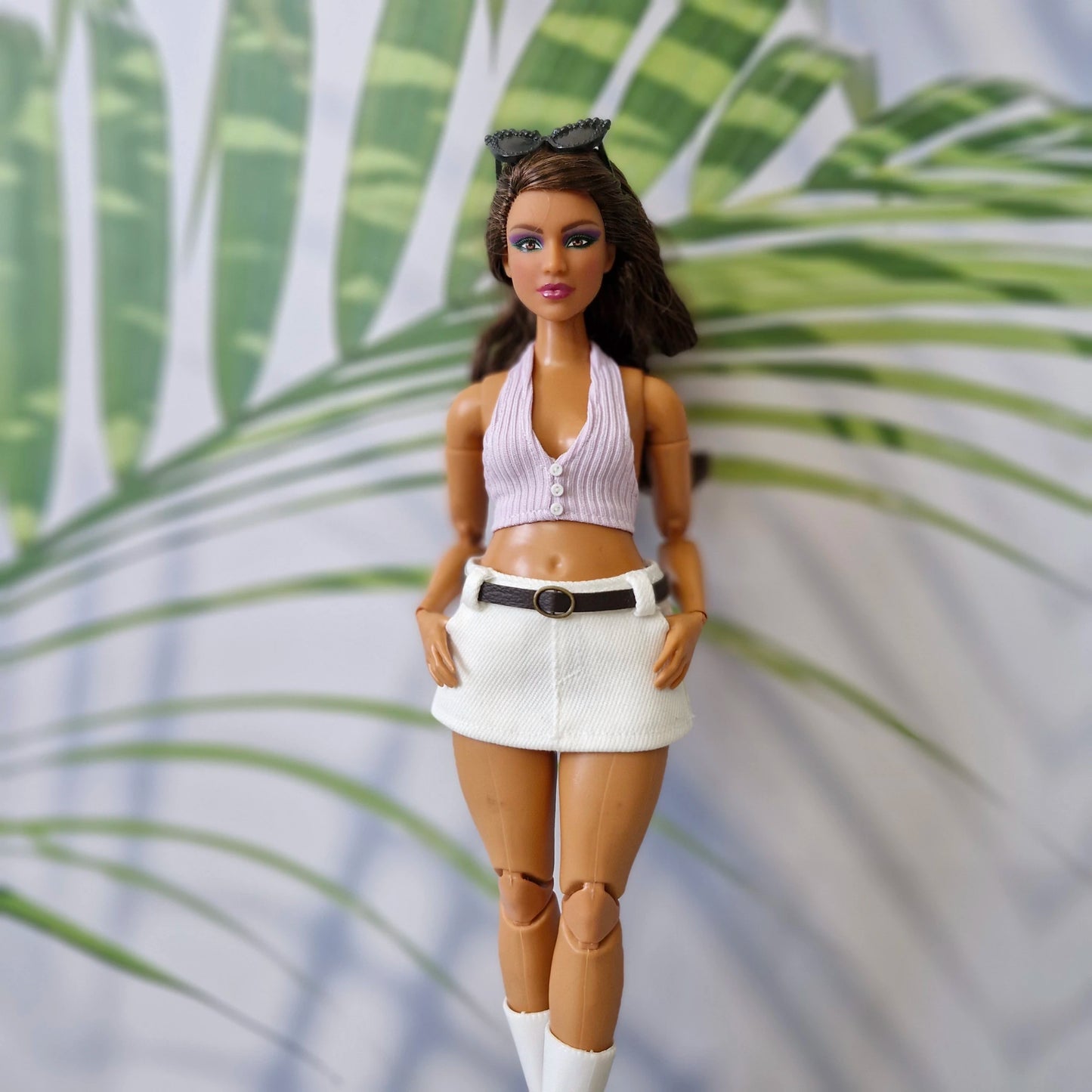 Curvy Barbie doll modeling a handmade 1/6 scale light purple ribbed halter top and white belted mini skirt.