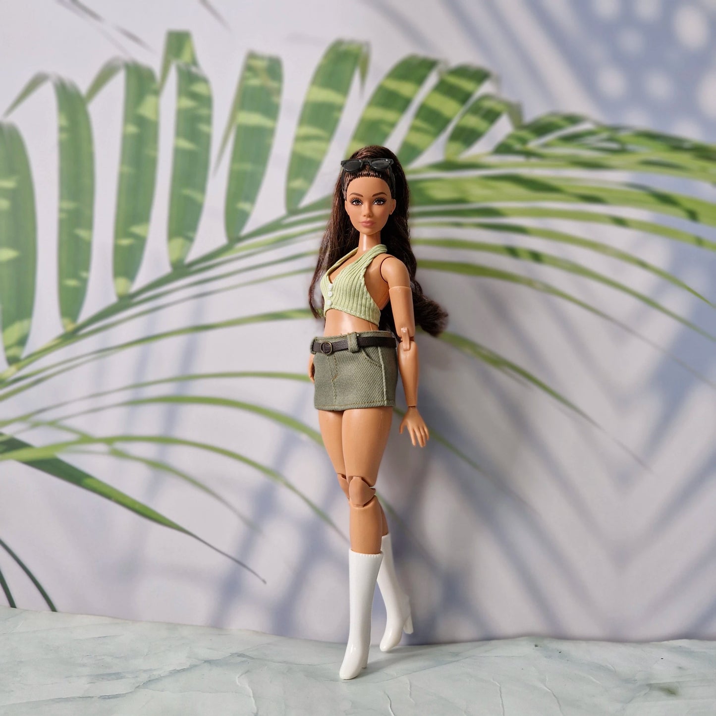 Curvy Barbie modeling a handmade 1/6 scale light green halter top and olive green mini skirt with a brown belt.