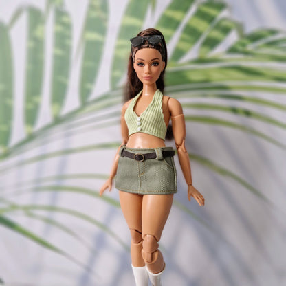 Close-up of a 1/6 scale Curvy fashion doll wearing a handmade green ribbed crop top and matching olive skirt separate.
