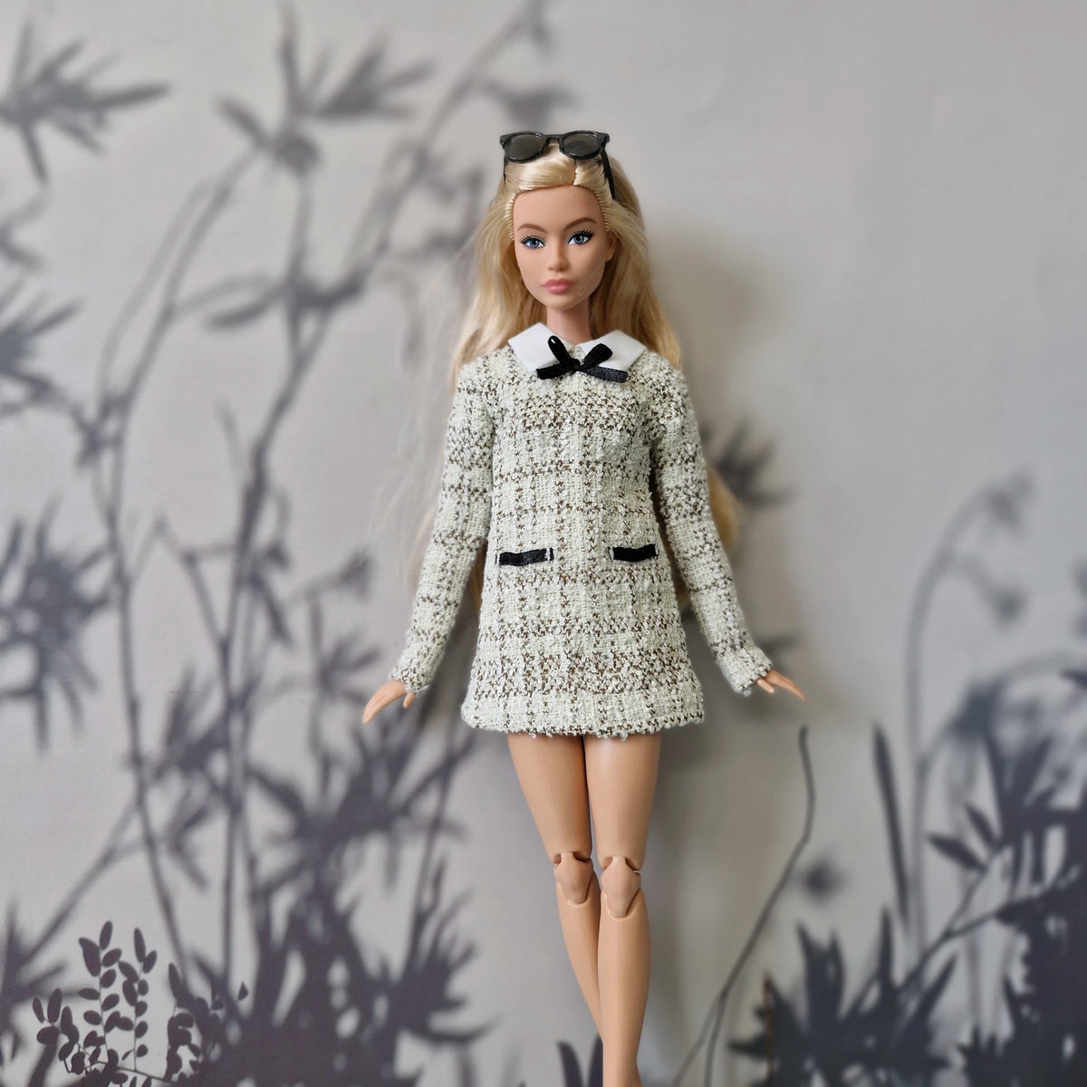 Standard blonde Barbie doll modeling a handmade black and white tweed mini dress.