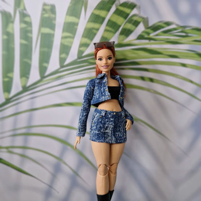 Close up of a redhead Curvy Barbie doll modeling a handmade medium acid wash denim jacket and matching mini skirt.