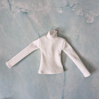 Flat lay of a handmade 1/6 scale white ribbed long-sleeve turtleneck top for Ken dolls.