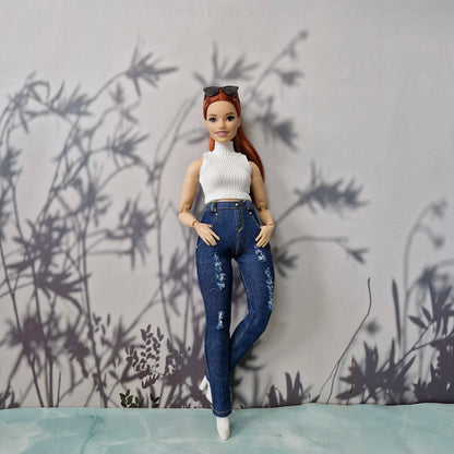 Full body shot of a redhead Curvy Barbie wearing a white turtleneck top and blue distressed jeans.