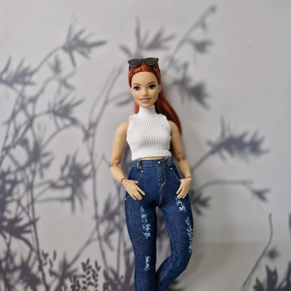 Close up of a Curvy Barbie doll in a handmade white ribbed sleeveless top and distressed denim.