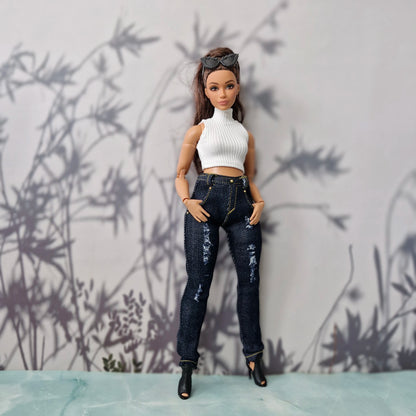 Full body view of a brunette Curvy Barbie doll modeling a handmade white top and denim jeans.