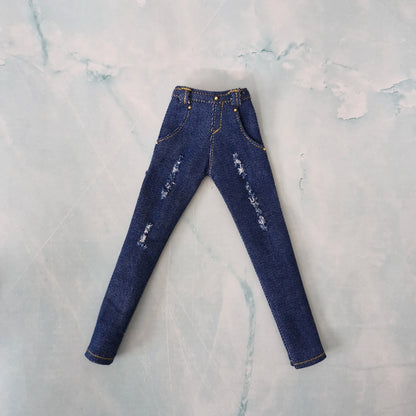 Flat lay of handmade 1/6 scale medium blue distressed denim jeans for Curvy Barbie.