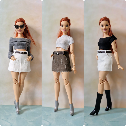 Three dolls with different outfits on a plain background