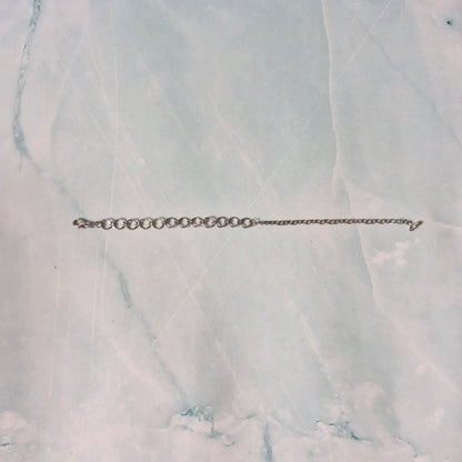 Silver chain bracelet on a marble surface