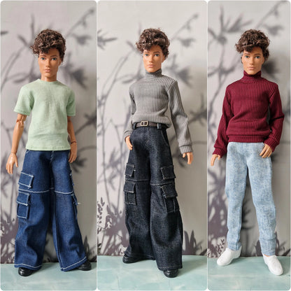 Three fashion dolls standing side by side, each wearing different outfits: a light green t-shirt with blue jeans, a gray ribbed turtleneck with dark cargo pants, and a burgundy ribbed turtleneck with light blue jeans.
