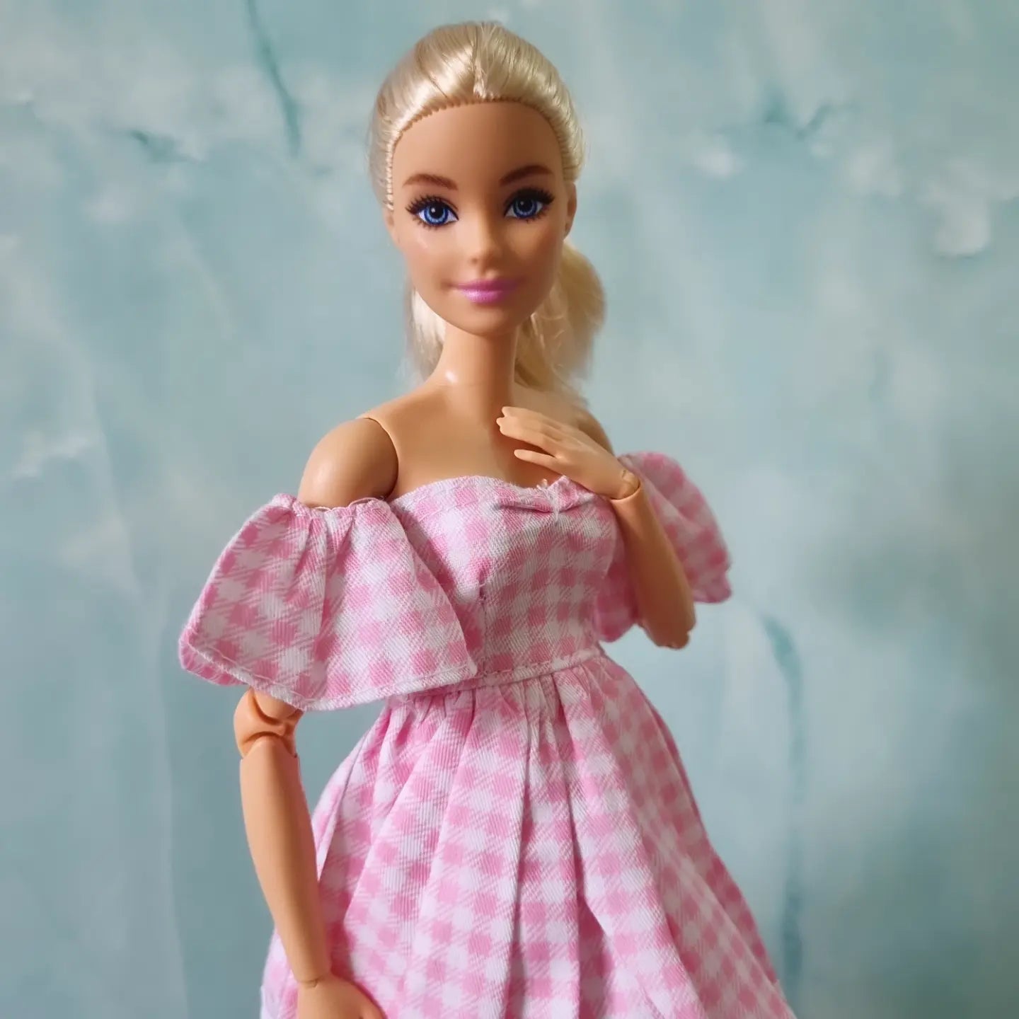 Barbie doll wearing pink gingham dress with puffy off-shoulder sleeves