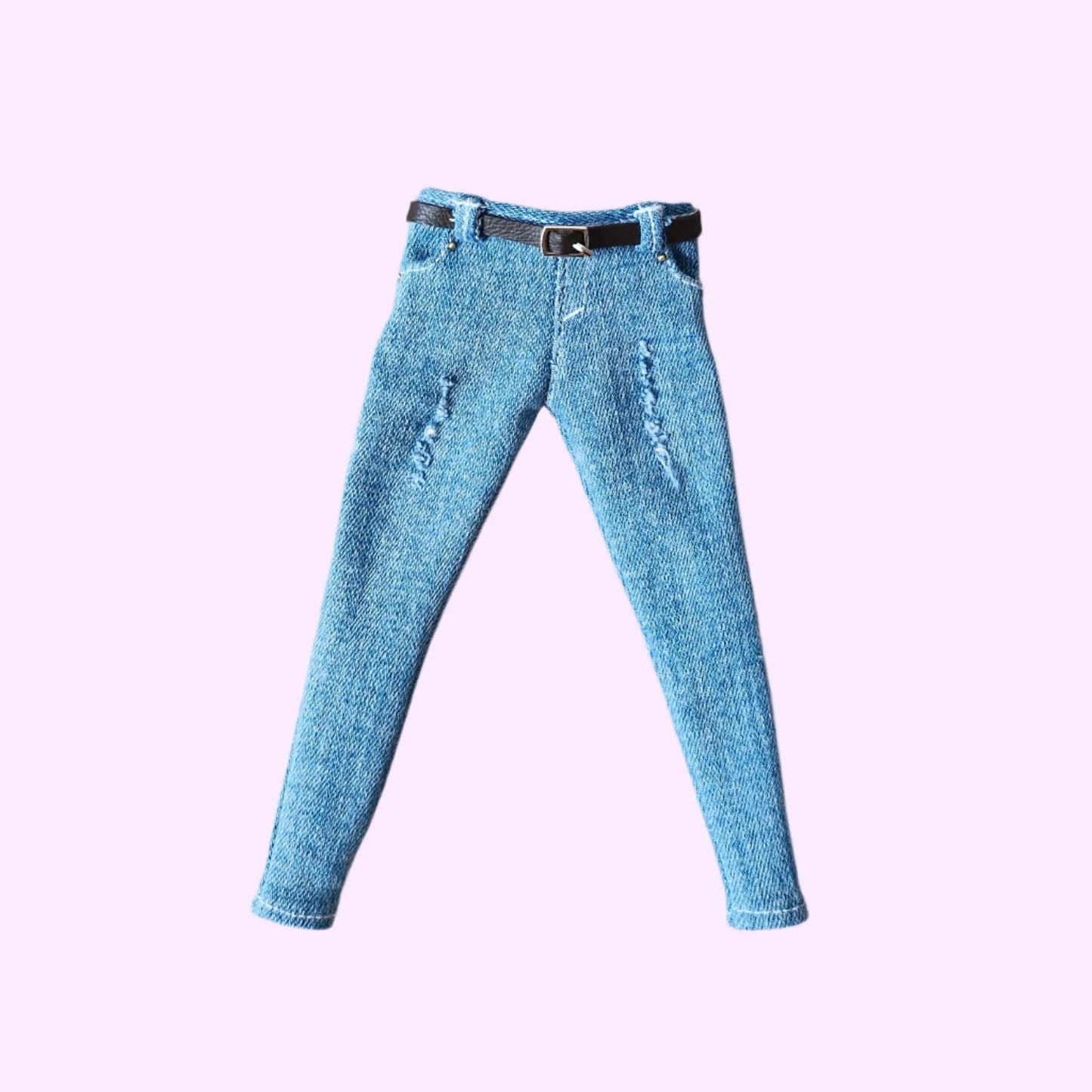 Curvy Barbie doll jeans: light blue distressed denim pants with belt, flat lay view.