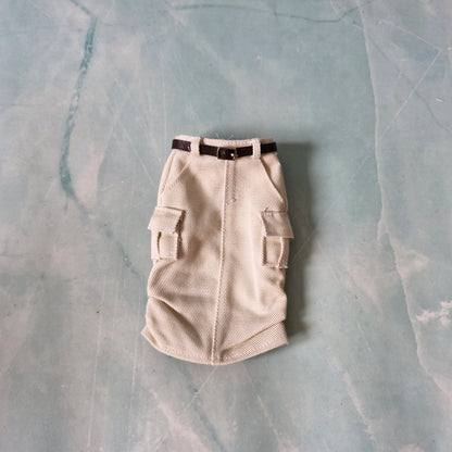 Beige cargo-style dog coat on a textured gray surface