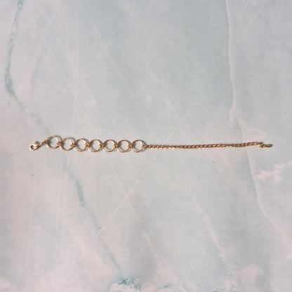 Gold bracelet on a marble surface